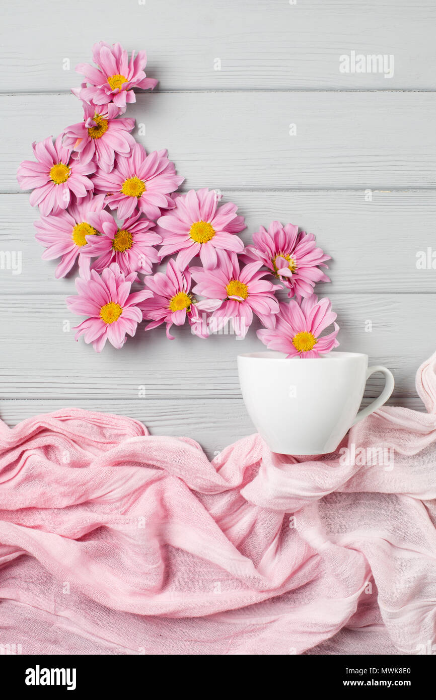 pink gerbera flowers fly out of a cup of tea Stock Photo