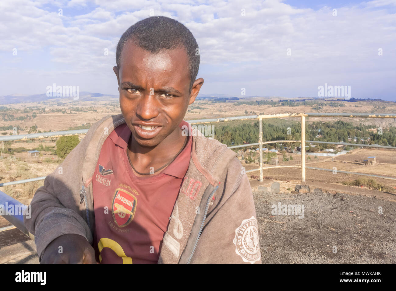 Debre Libanos, Ethiopia - February 17, 2015: Ethiopian teenage boy is standing at the viewpoint at the road number 3 near Debre Libanos in Ethiopia. Stock Photo