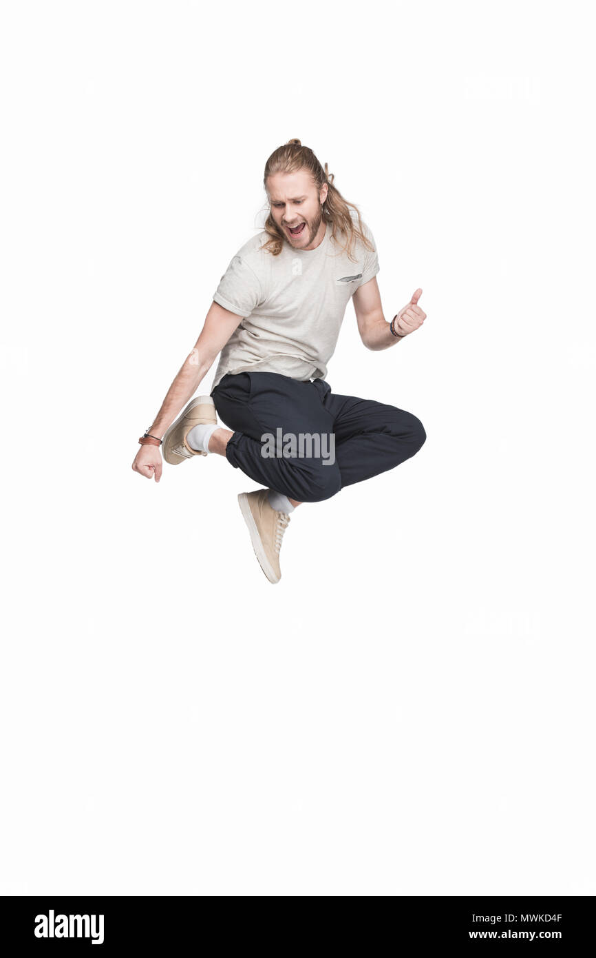 excited caucasian man jumping in black jeans, isolated on white Stock Photo
