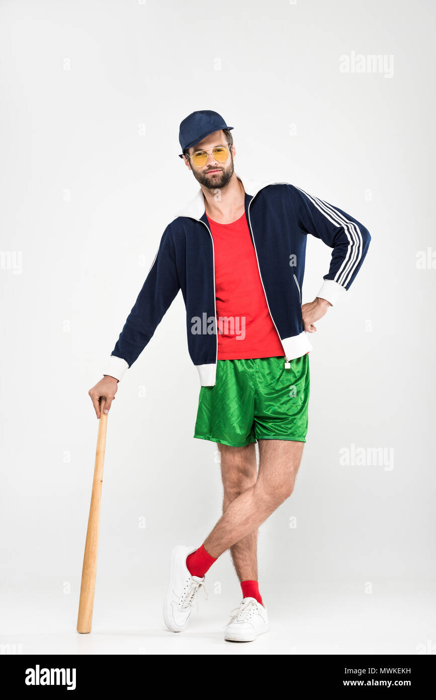 retro baseball player posing in cap with baseball bat, isolated on white Stock Photo