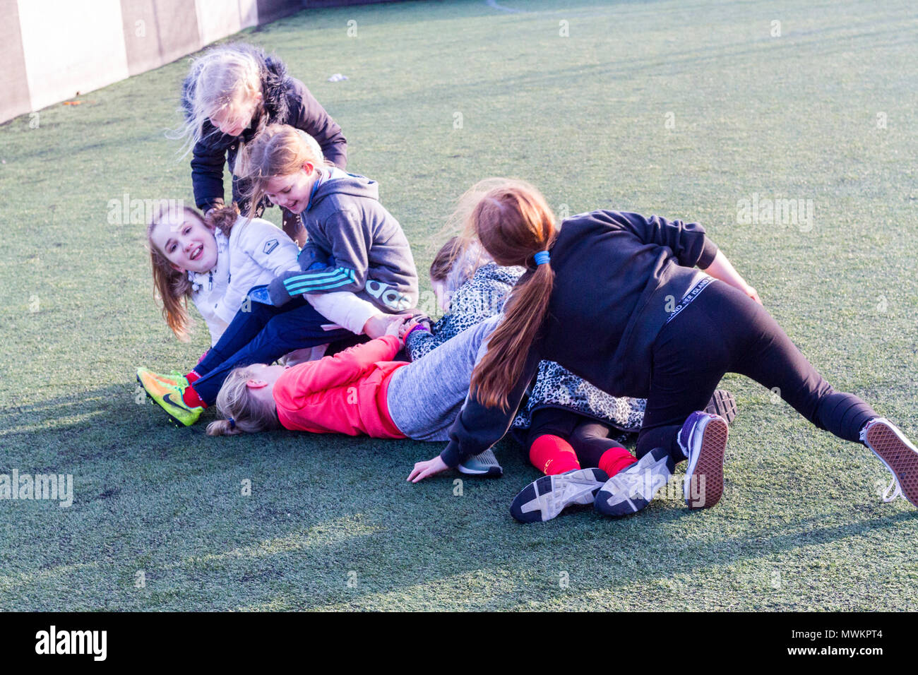 Children messing around, kids messin around, laughing having fun on the ground, childhood fun, memories Stock Photo