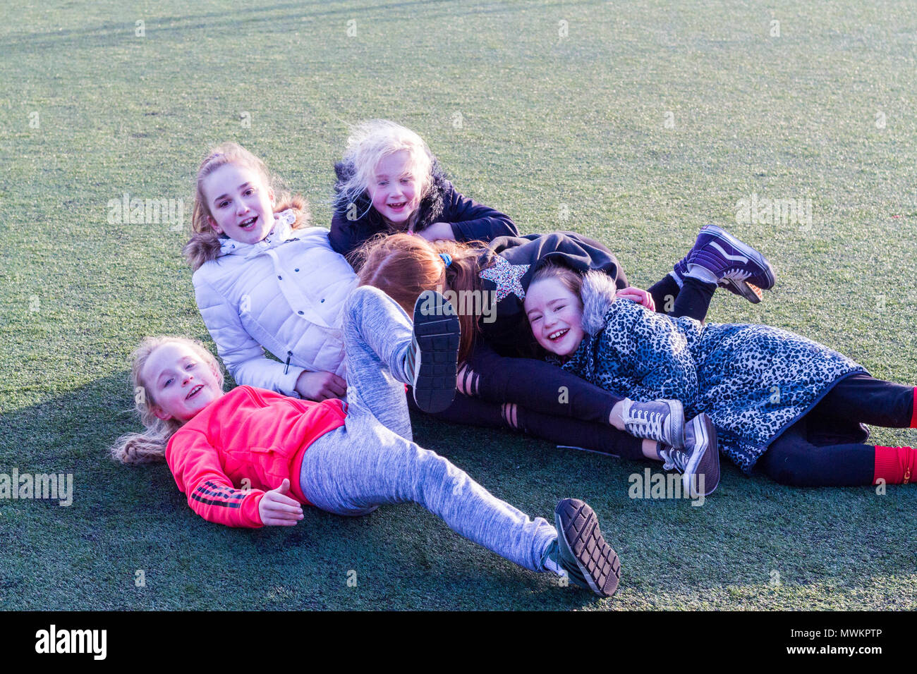 Children messing around, kids messin around, laughing having fun on the ground, childhood fun, memories Stock Photo