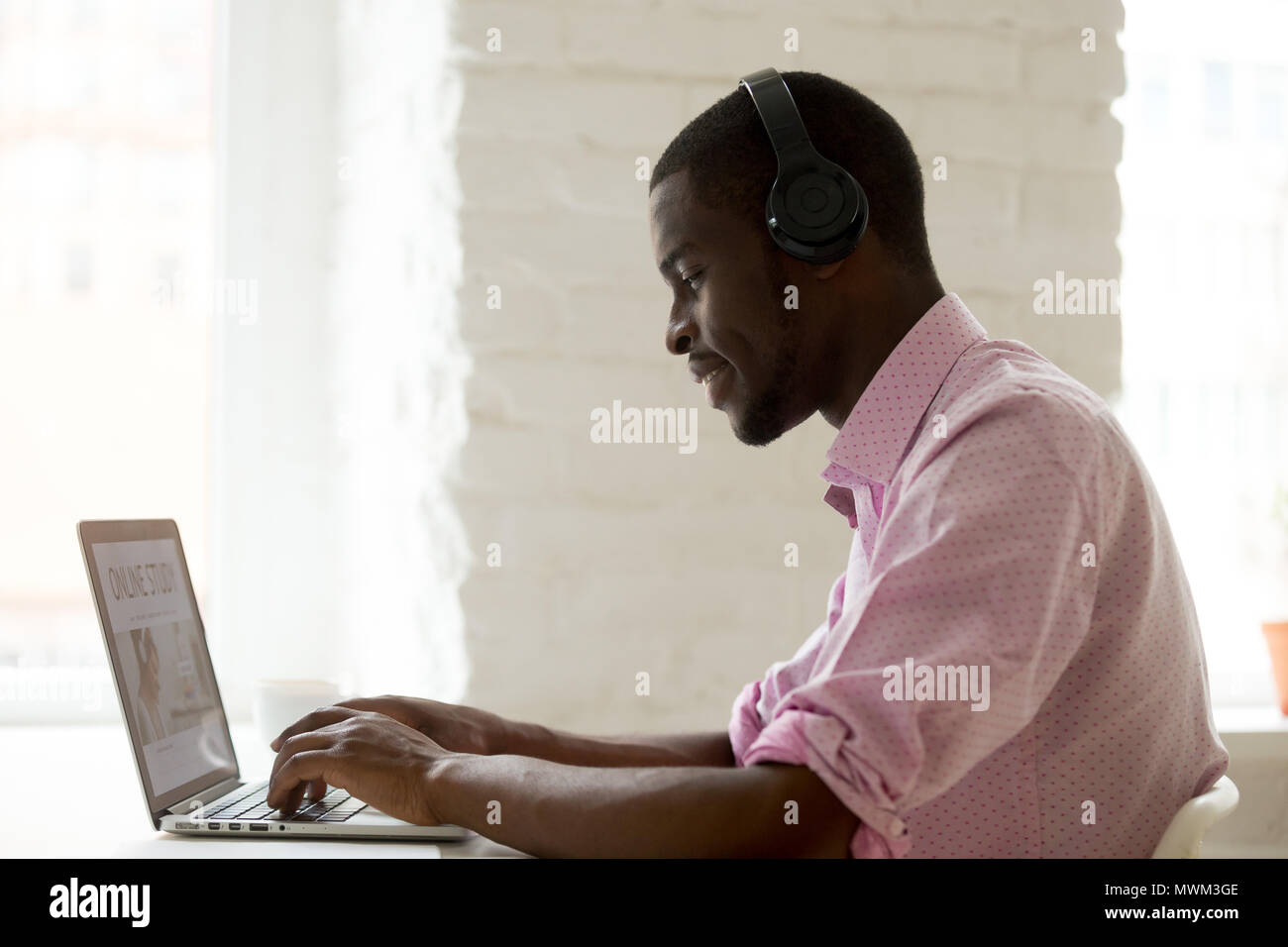 Happy African American in headphones taking online course Stock Photo