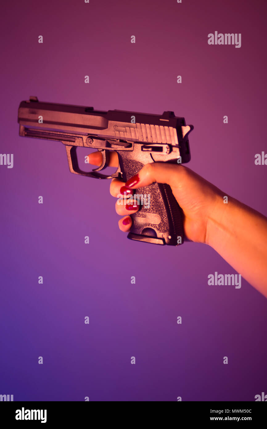 Woman's hand holding automatic pistol gun Stock Photo Alamy