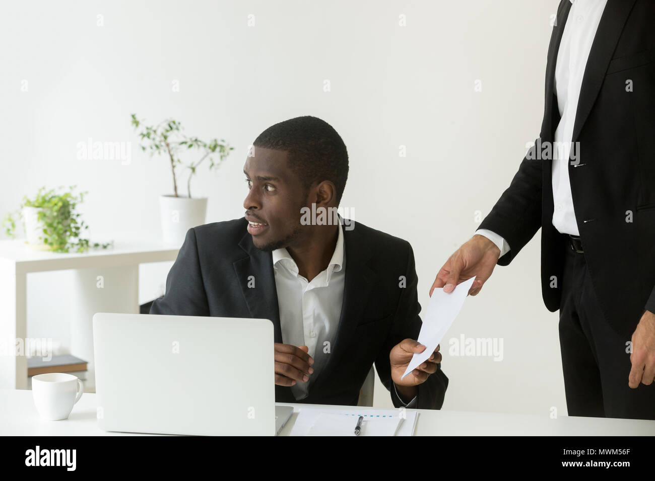 Worker giving bribe to office colleague Stock Photo