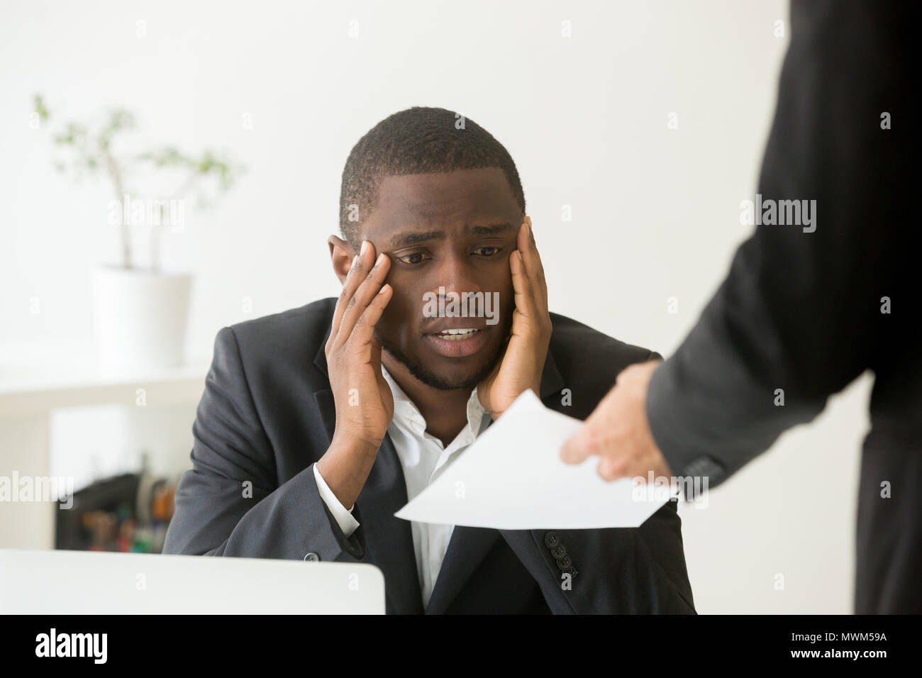 Upset African American worker getting dismissal notice  Stock Photo
