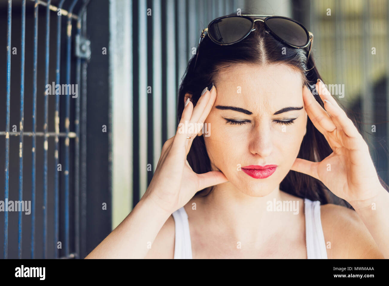 Headache The Woman Is Holding Her Hands Behind Her Head Feeling Of A Headache By A Female The