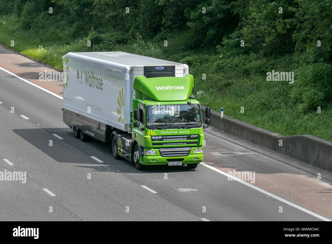 Waitrose 9186cc diesel food truck, running on 100% renewable Bio fuel, supply chain supermarket delivery trucks; Heavy goods, Scania P340 commercial traffic on the M6 southbound, UK Stock Photo