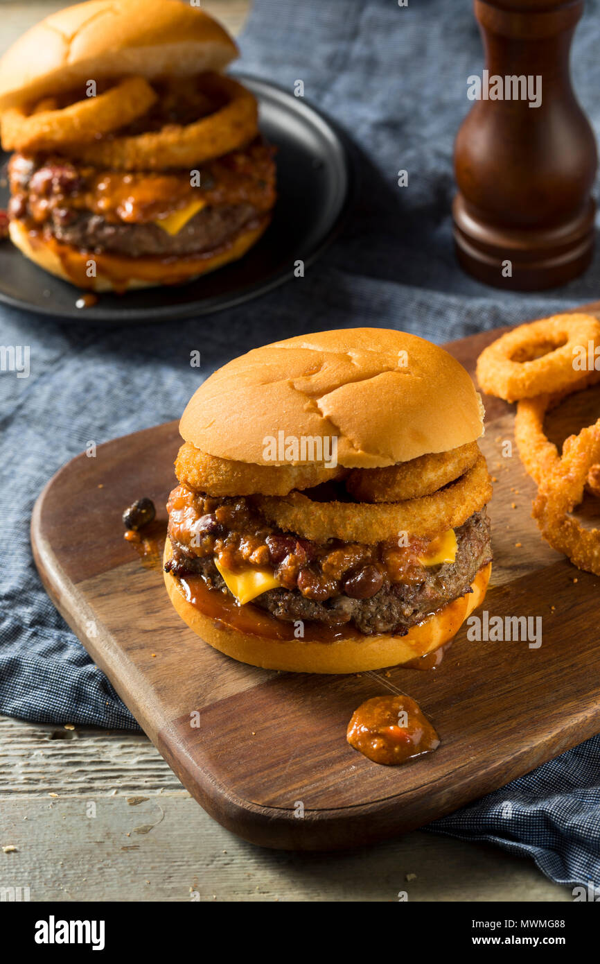 Homemade Barbecue Chili Cheeseburger with Onion Rings Stock Photo