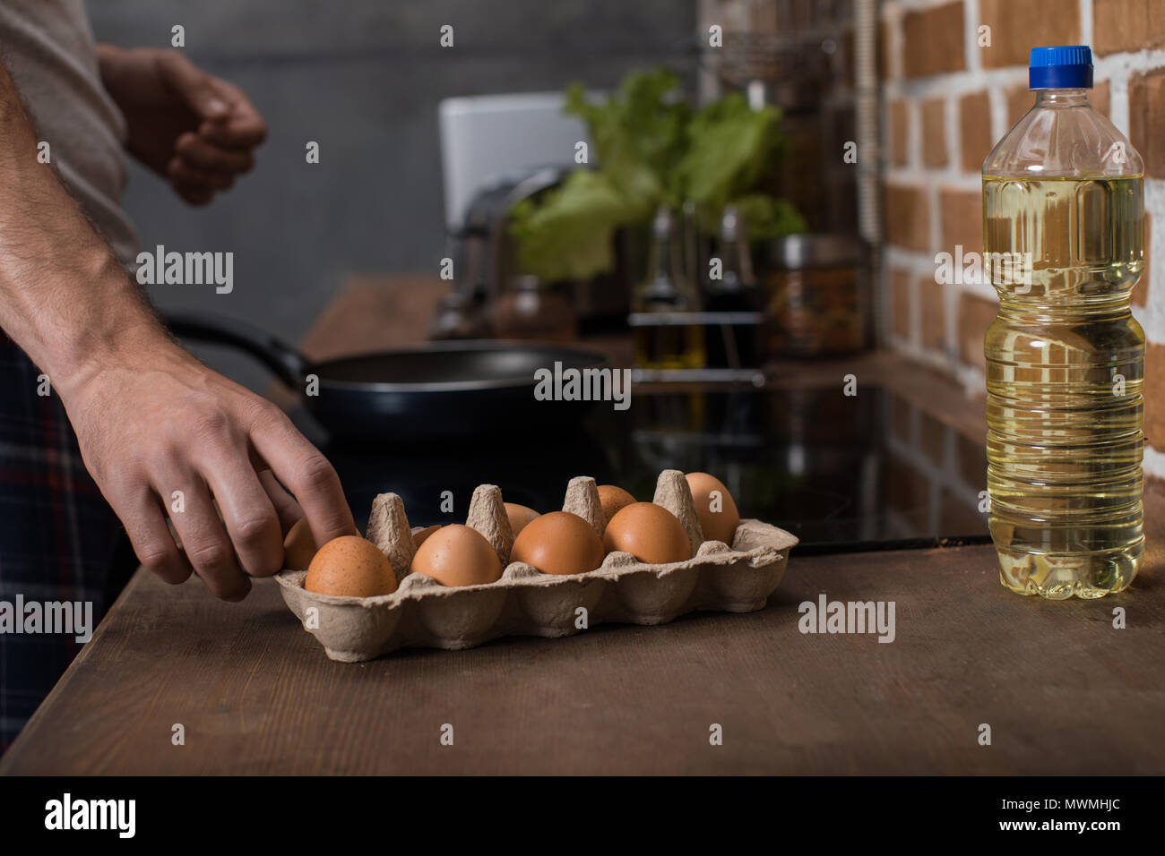 partial view of young man preparing food breakfast in kitchen at home Stock Photo