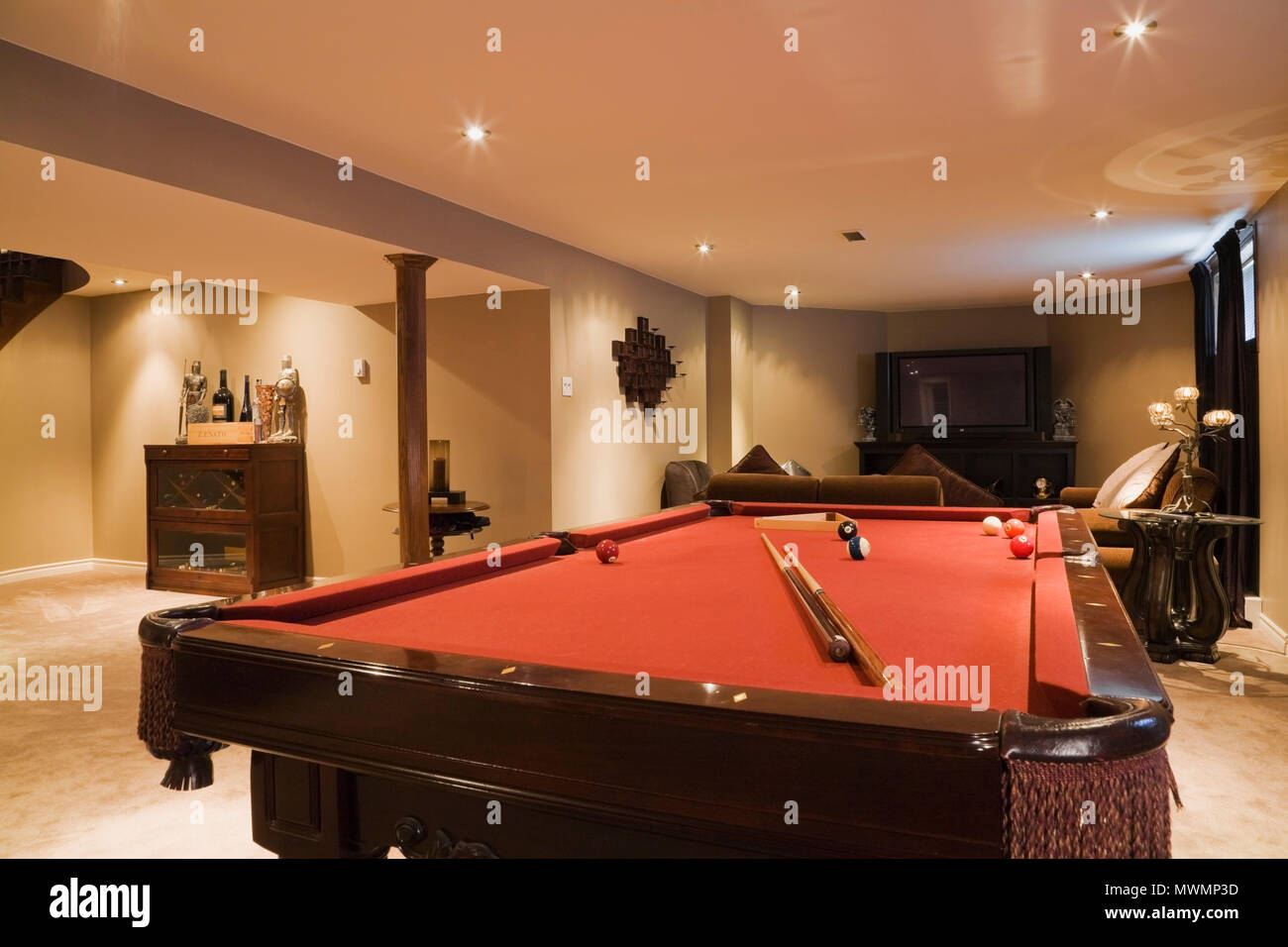 Playroom with pool table in the basement of a luxurious cottage style
