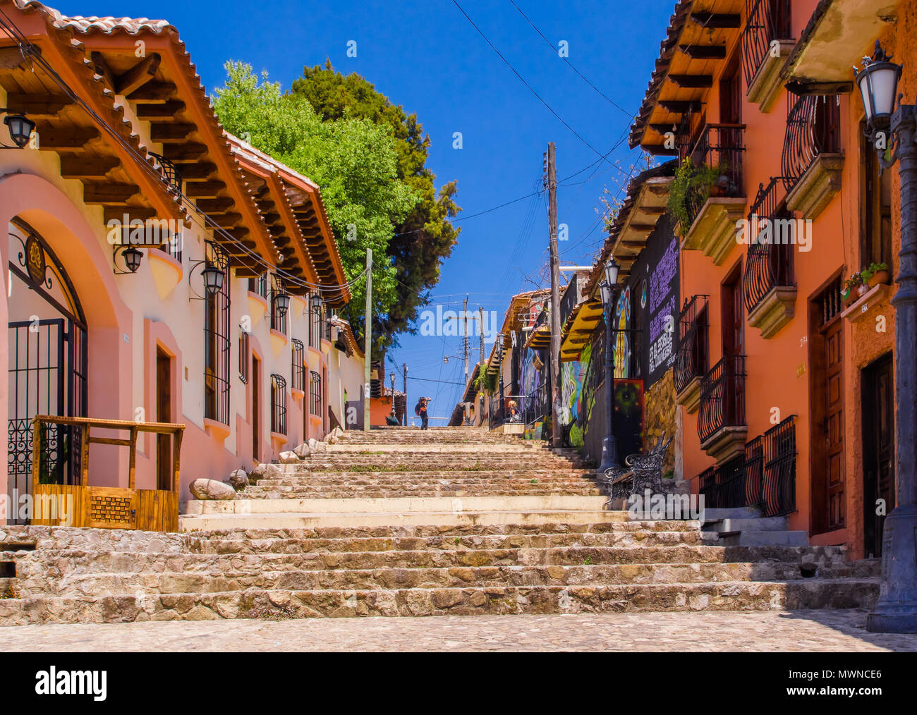 SAN CRISTOBAL DE LAS CASAS, MEXICO, MAY, 17, 2018: Outdoor view of teens walking to a hill with colorful steps in San Cristobal de las Casas, Chiapas Stock Photo