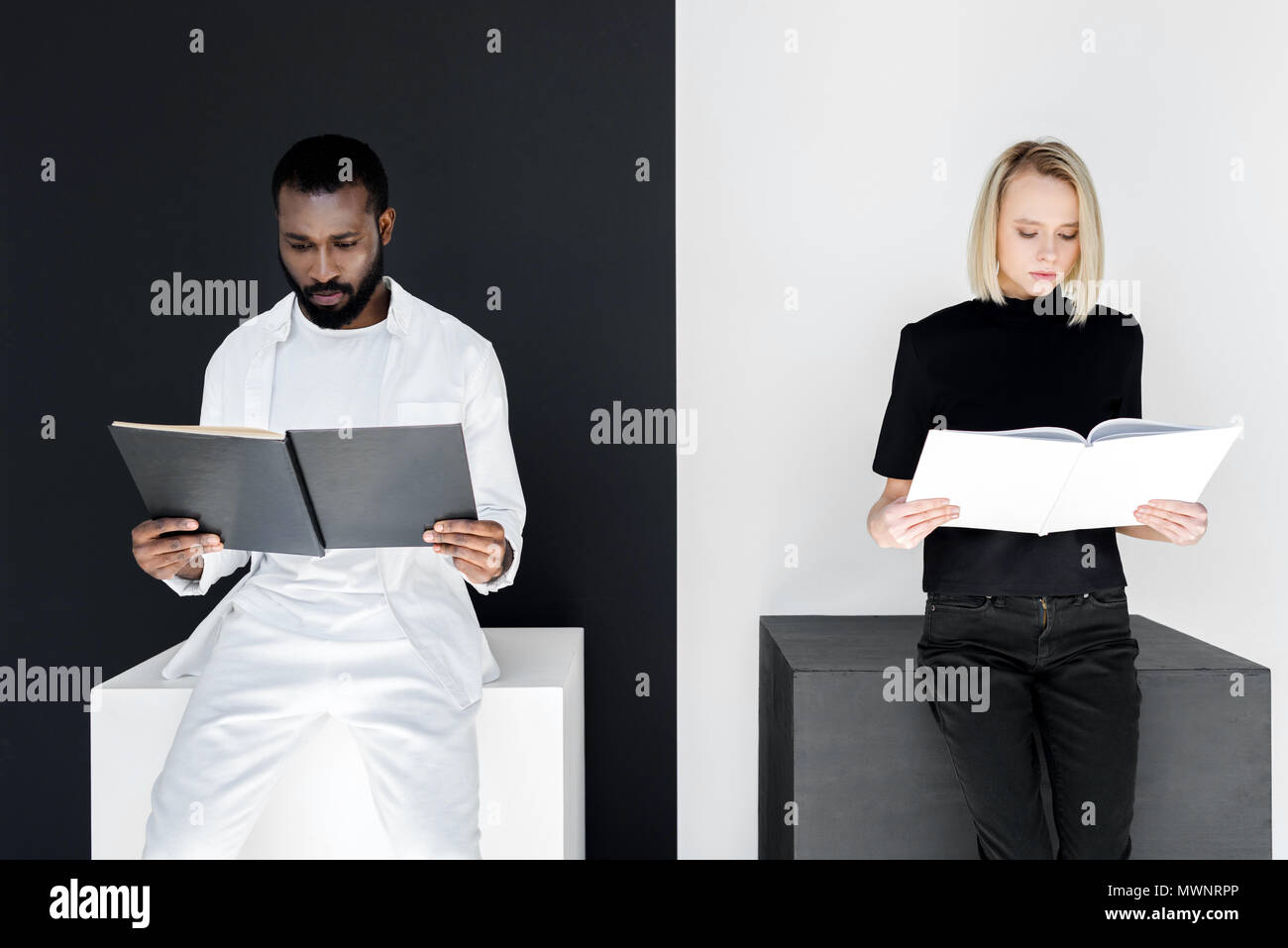 multicultural couple reading black and white books, yin yang concept ...