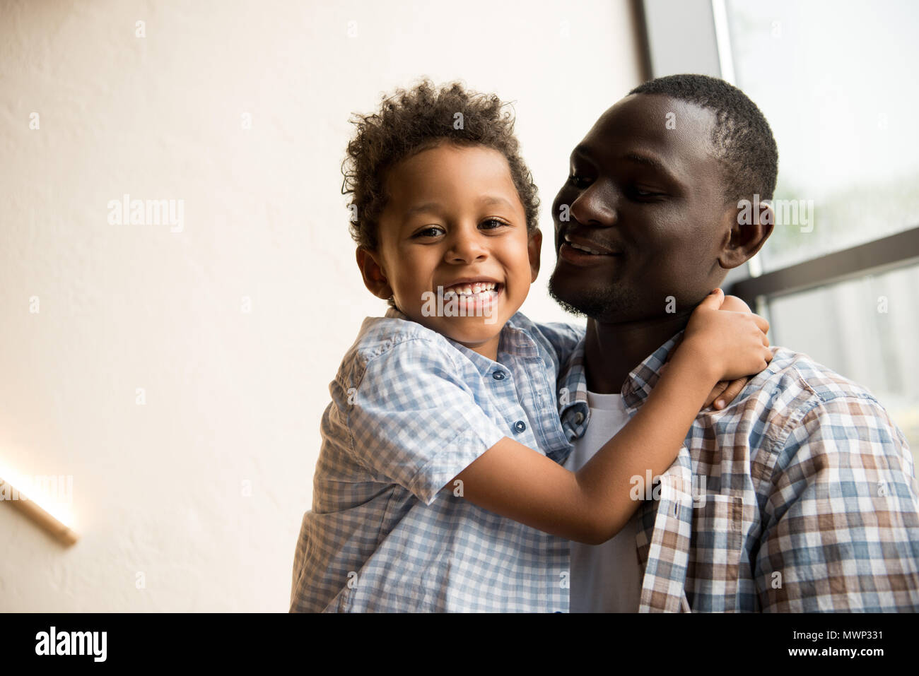 happy african american father and cute little son hugging indoors Stock ...
