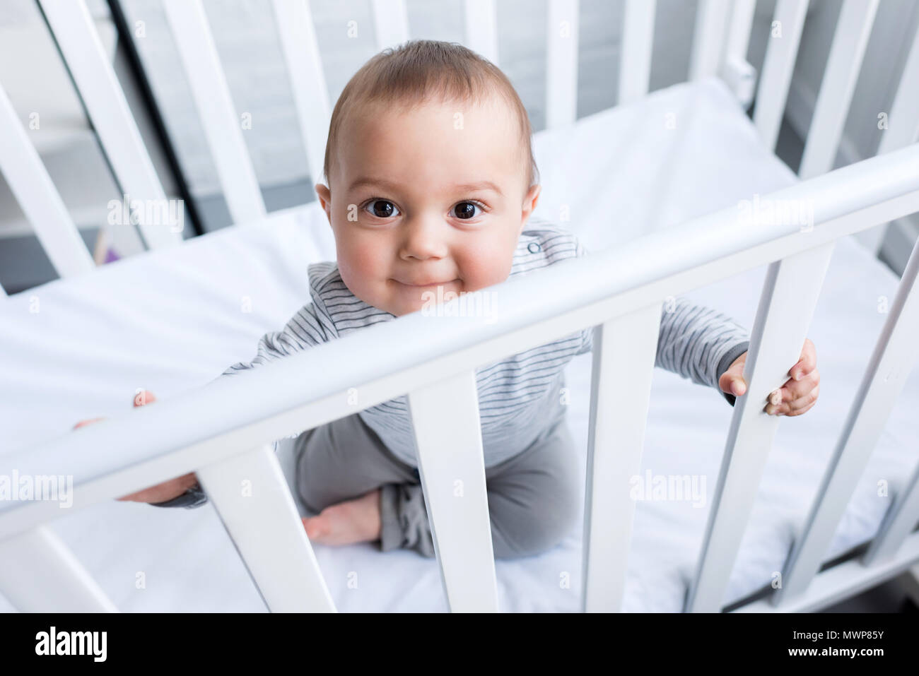 Baby boy sitting in cot hires stock photography and images Alamy