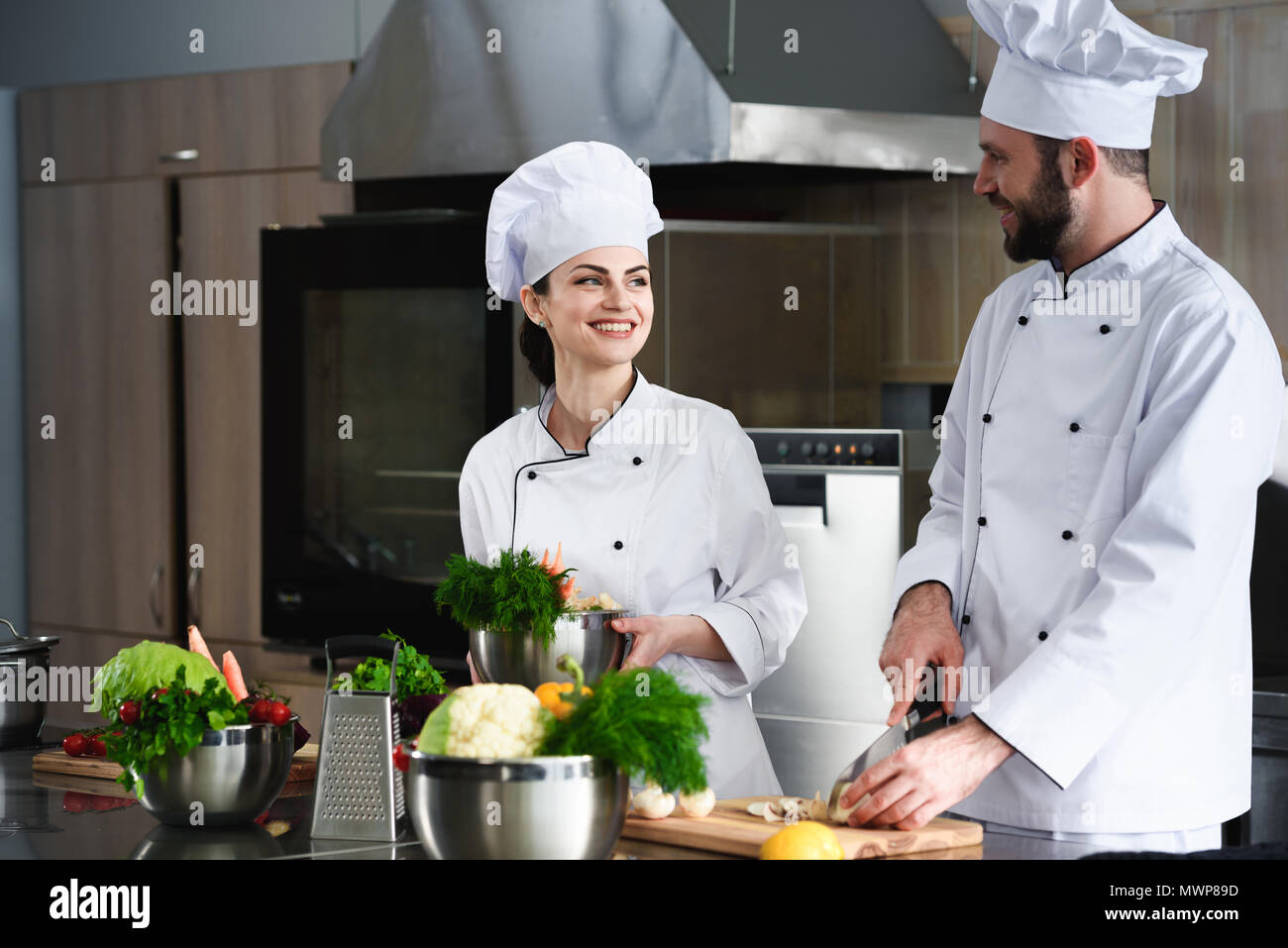 Professional chefs discussing recipe and cooking on kitchen Stock Photo