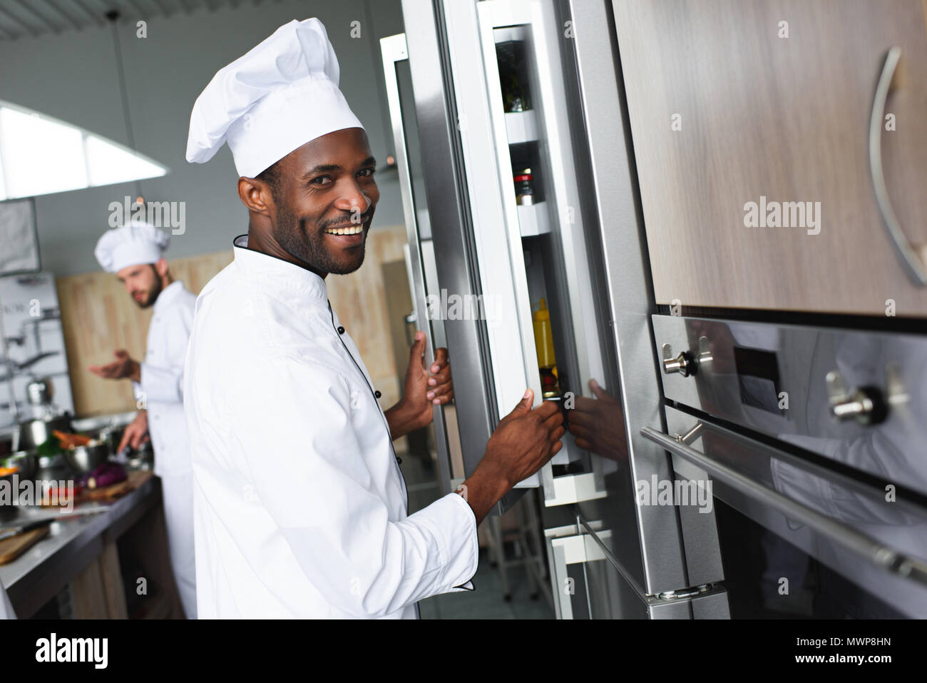 Multiracial team of cooks working on professional restaurant kitchen Stock Photo