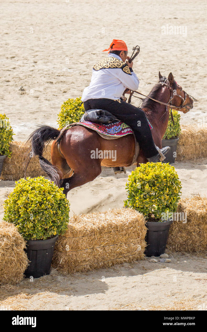Horseman riding in their ethnic clothes on horseback Stock Photo Alamy