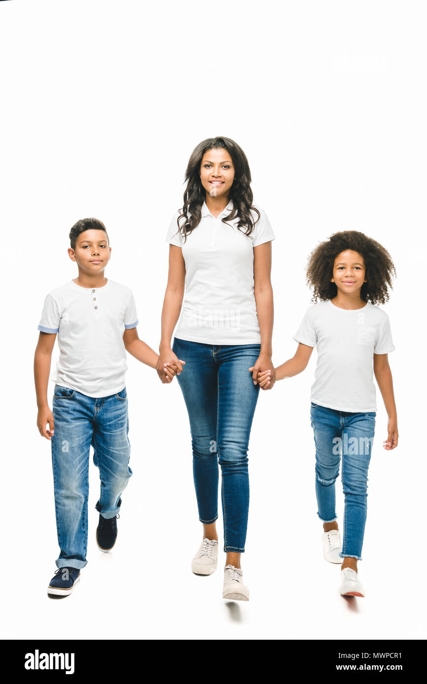 Portrait Of Happy Family Walking Over White Background Against