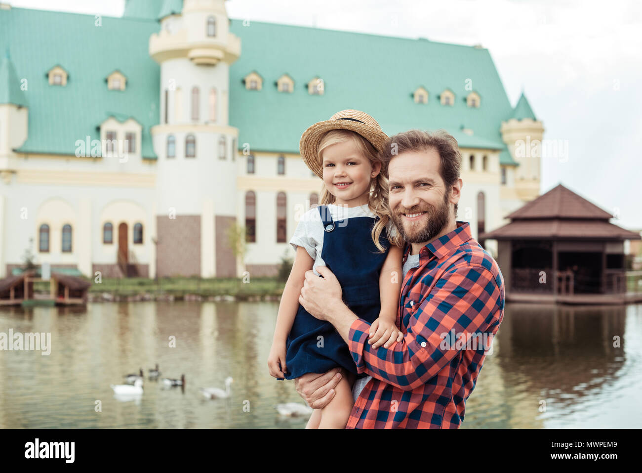 happy father holding little daughter in hands in park Stock Photo - Alamy