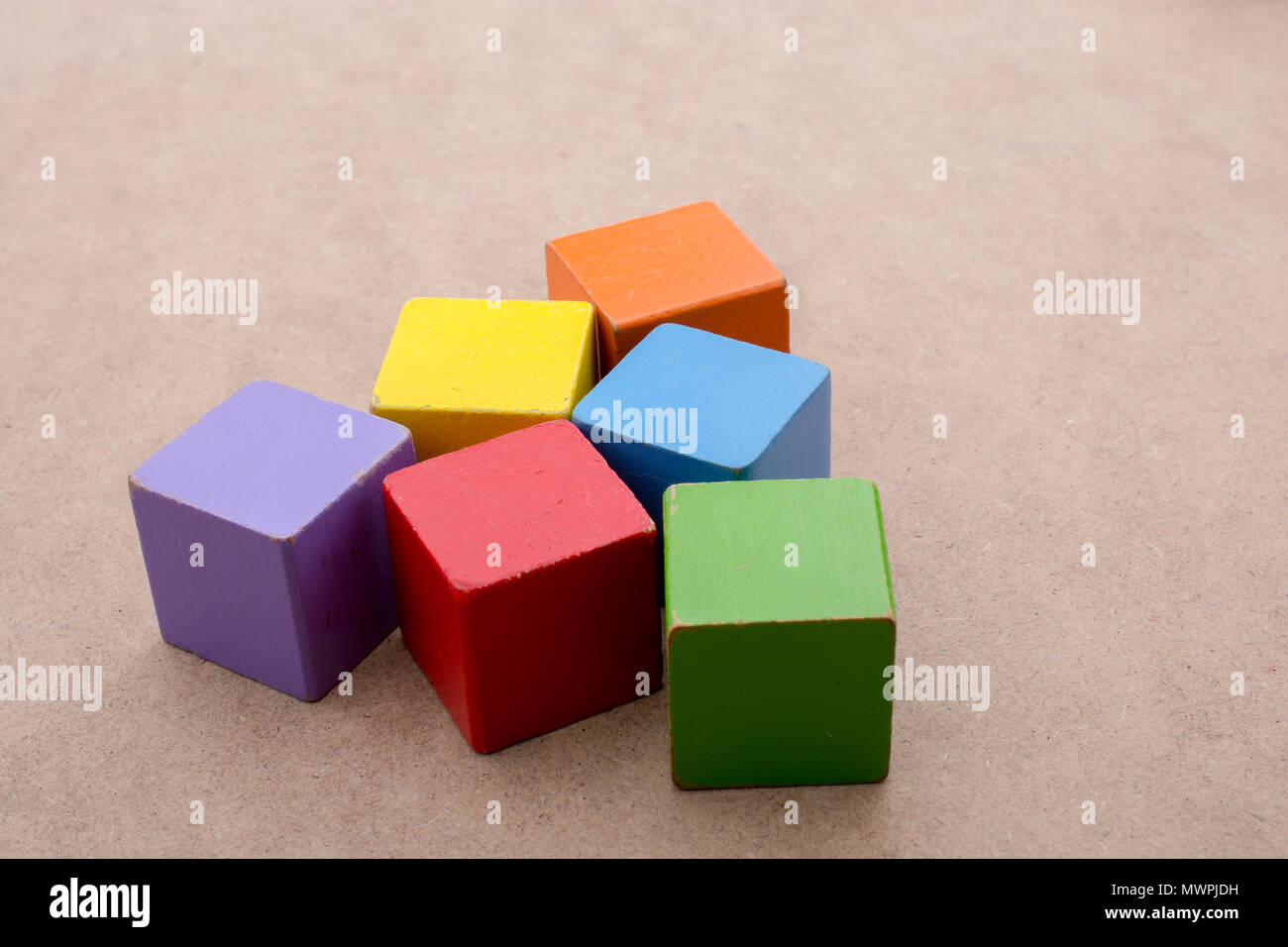 Colorful building blocks on a brown background Stock Photo - Alamy