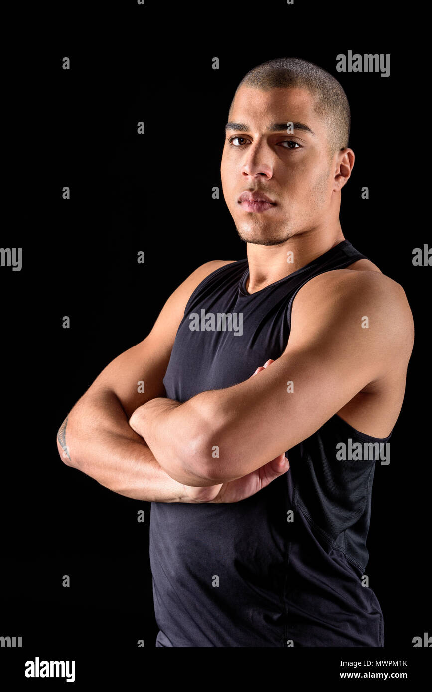 African american man standing with crossed arms isolated on black Stock ...