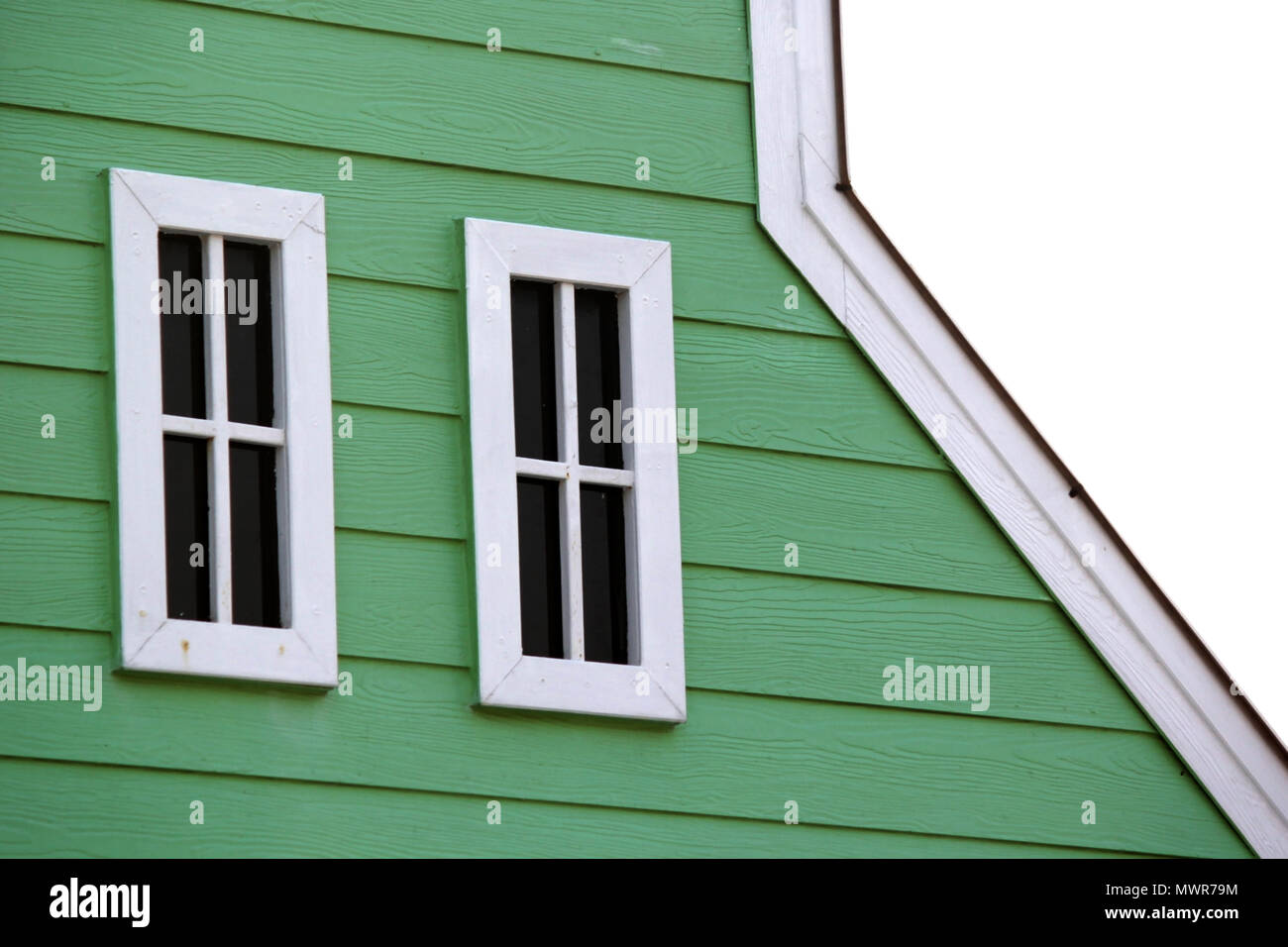 gable roof with white windows on wooden house Stock Photo