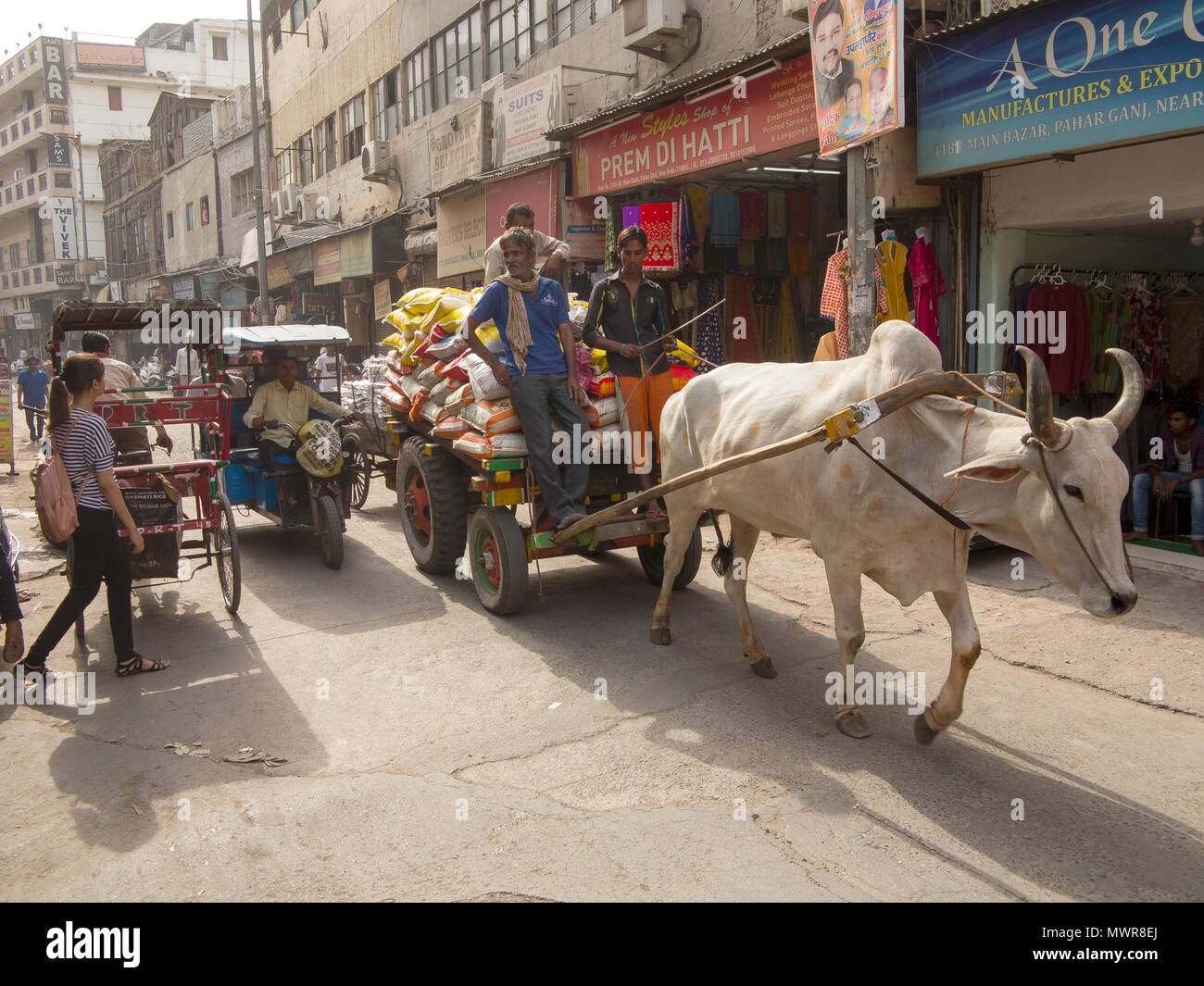 Cart pulled by a bullock being used as a grain transport vehicle at Pahar Ganj Main Bazar, New Delhi, India Stock Photo