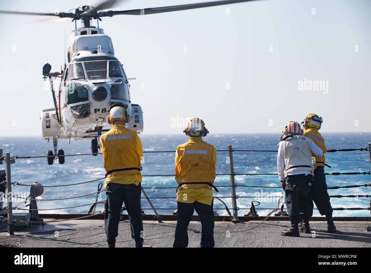 180516-N-AV754-0107 U.S. 5TH FLEET AREA OF OPERATIONS (May 16, 2018) Sailors aboard the Arleigh Burke-class guided-missile destroyer USS Winston S. Churchill (DDG 81) guide a Eurocopter AS332 Super Puma during a replenishment-at-sea with the dry cargo and ammunition ship USNS Amelia Earhart (T-AKE 6). Winston S. Churchill is deployed to the U.S. 5th Fleet area of operations in support of maritime security operations to reassure allies and partners and preserve the freedom of navigation and the free flow of commerce in the region. (U.S. Navy photo by Mass Communication Specialist 3rd Class Evan Stock Photo
