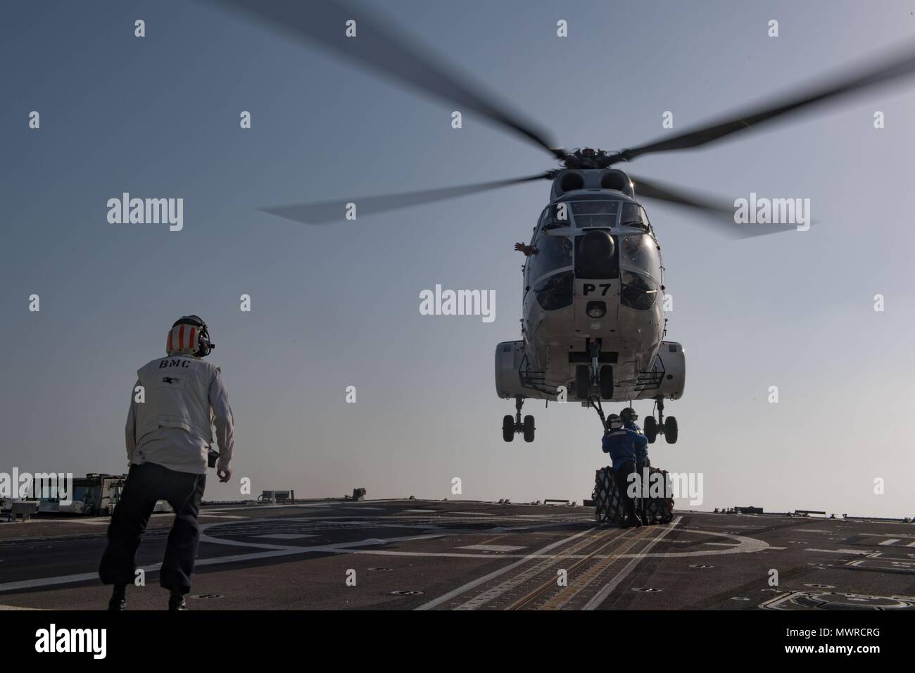 180510-N-AV754-0172 U.S. 5TH FLEET AREA OF OPERATIONS (May 10, 2018) Sailors assigned to the Arleigh Burke-class guided-missile destroyer USS Winston S. Churchill (DDG 81) attached cargo to a Eurocopter AS332 Super Puma helicopter during a vertical replenishment with the dry cargo and ammunition ship USNS Amelia Earhart (T-AKE 6). Winston S. Churchill is deployed to the U.S. 5th Fleet area of operations in support of maritime security operations to reassure allies and partners and preserve the freedom of navigation and the free flow of commerce in the region. (U.S. Navy photo by Mass Communica Stock Photo