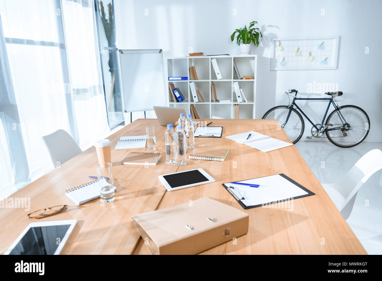 view of empty office interior with table and bicycle against wall Stock Photo