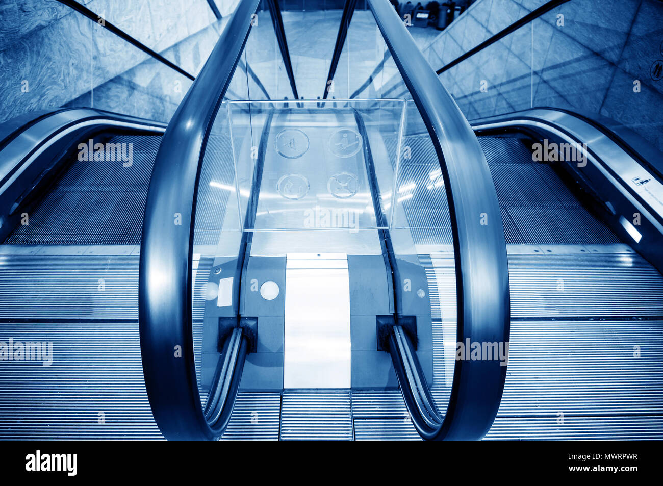 Blue escalator in airport hall, Shanghai, China. Stock Photo