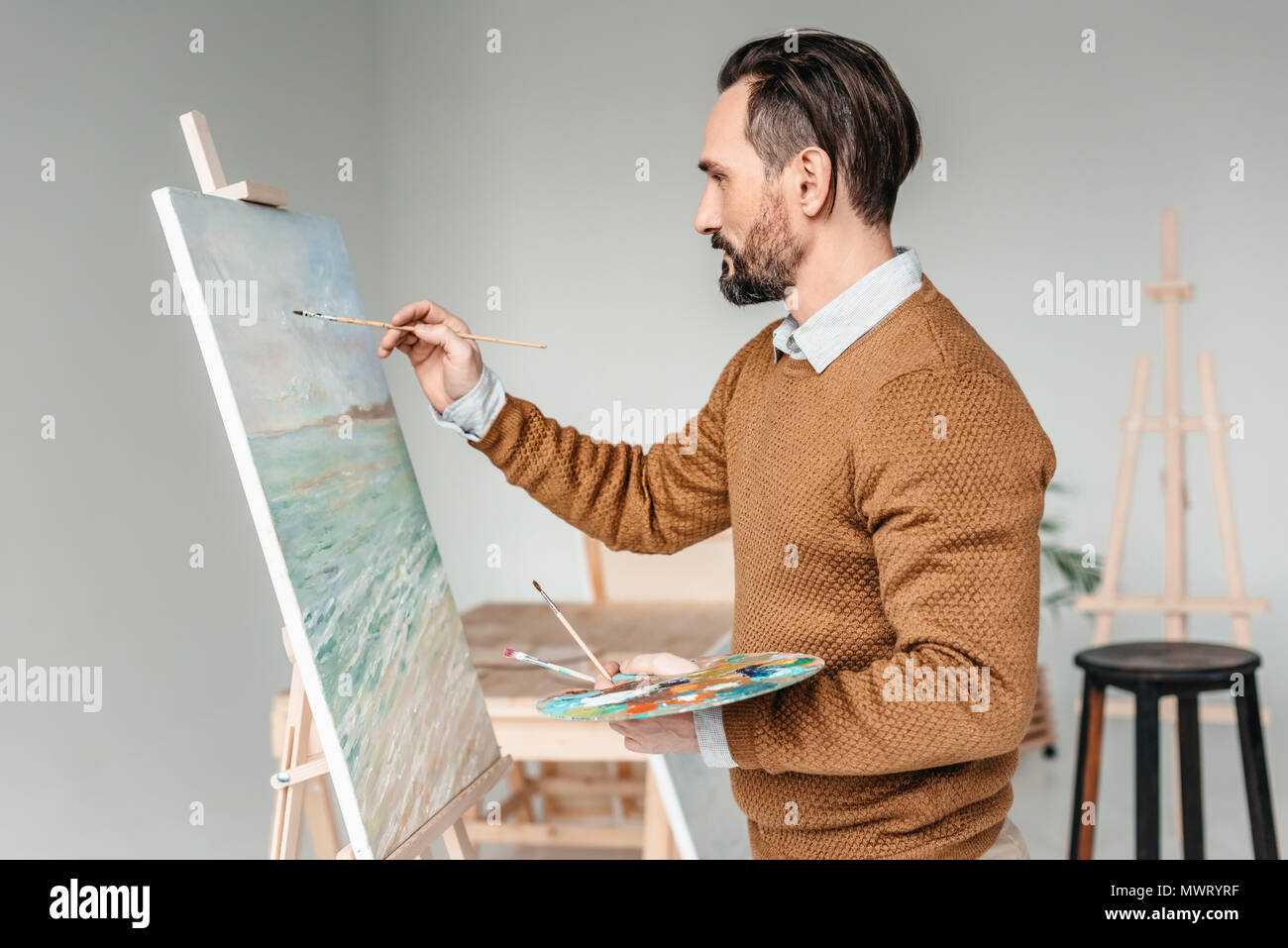 Man painting at easel hi-res stock photography and images - Alamy