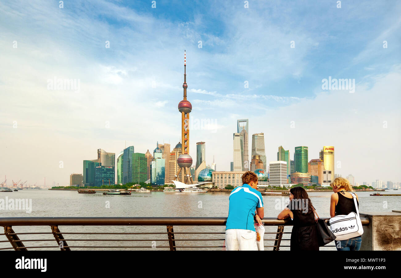 SHANGHAI-MAY 14, 2012. Tourists on Bund boulevard with Pudong district on background. Pudong district houses Lujiazui Finance and Trade Zone and Shang Stock Photo