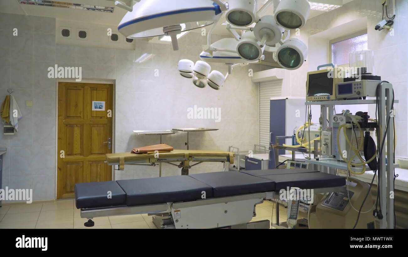 Operating room at hospital with equipment and medical devices. Table for surgical operations in