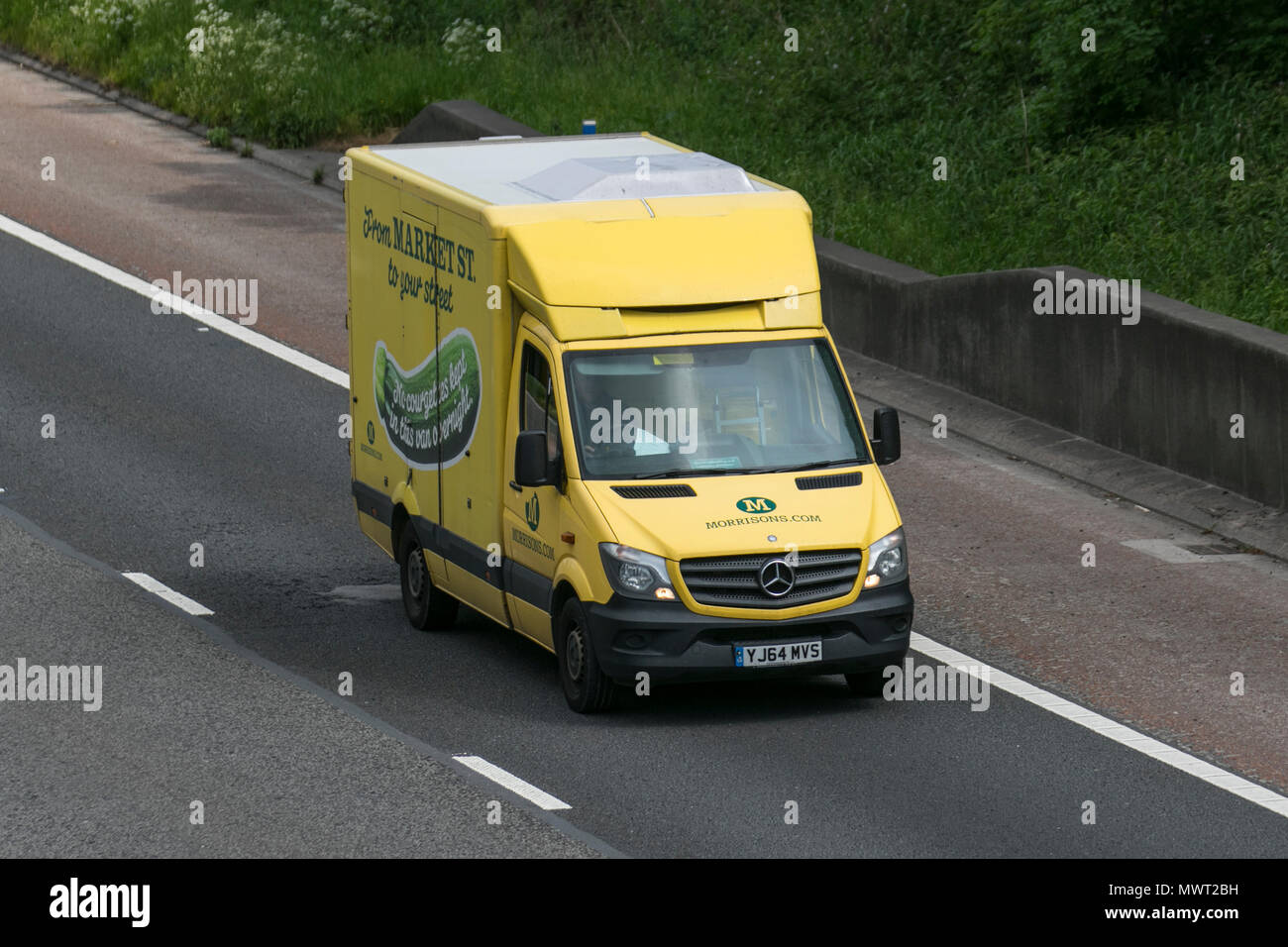 Ocado & Morrisons supermarket grocery delivery service food store vehicles; online delivery fleet delivering, groceries & household essentials in Liverpool, Merseyside, UK Stock Photo