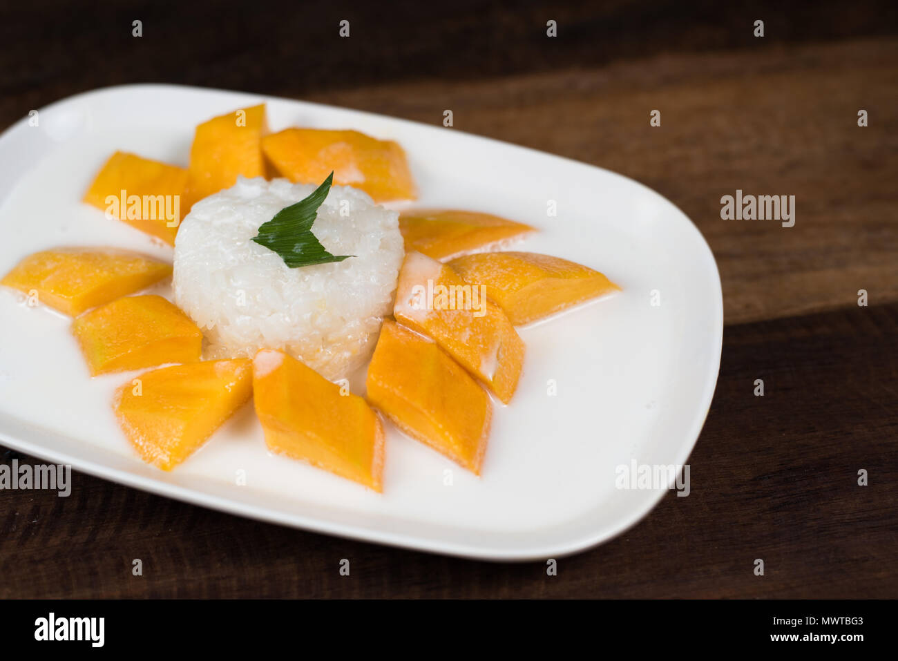 mango sticky rice or Khaoniao mamuang on a wooden table, a traditional ...