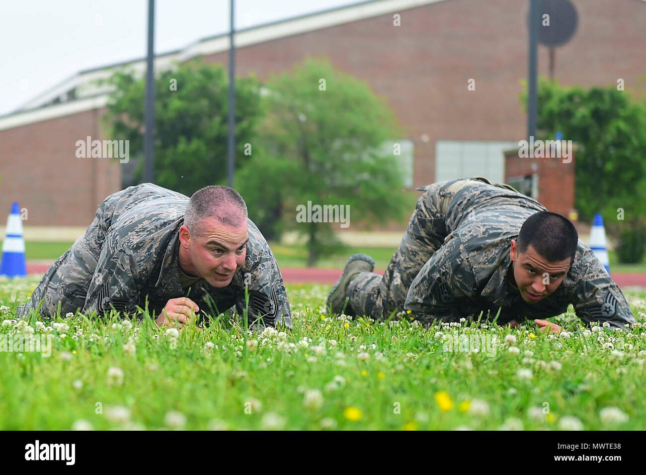 Members of the 633rd Security Forces Squadron Emergency Services Team perform a high crawl during a modified Marine Combat Physical Test at Joint Base Langley-Eustis, Va., April 28, 2017. The team provide services equal to a civilian police SWAT (Special Weapons and tactics) Team , to the installation and train to handle hostage and barricaded suspect situations. Stock Photo