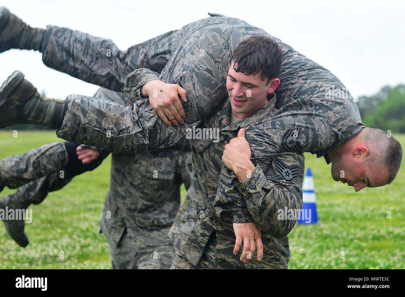 U.S. Air Force Staff Sgt. Gary Good, 633rd Security Forces Squadron unit trainer, performs a buddy carry during a modified Marine Combat Fitness Test at Joint Base Langley-Eustis, Va., April 28, 2017. During the modified Marine Combat Physical Test, Good and his fellow members of the 633rd SFS Emergency Services Team performed a low crawl, high crawl and a fireman carry. Stock Photo