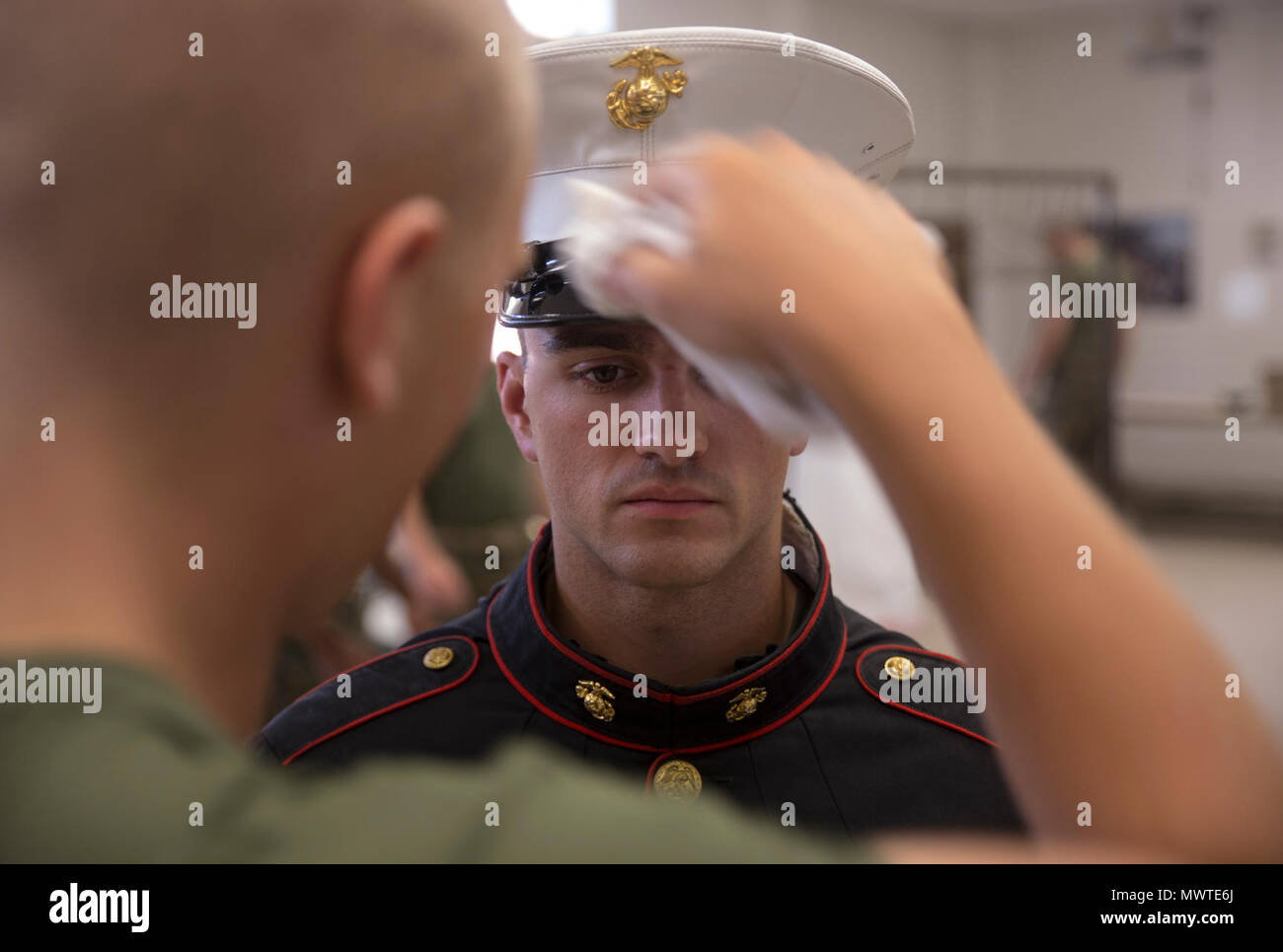 Rct. Jack T. Fischer, Platoon 3044, Lima Company, 3rd Recruit Training Battalion, stands at attention while his cover is cleaned April 27, 2017, on Parris Island, S.C. Recruits take time to ensure their grooming and uniforms meet Marine Corps standards before taking their first official Marine Corps photograph. Fischer, 21, from Miller Place, N.Y., is scheduled to graduate June 16, 2017. Parris Island has been the site of Marine Corps recruit training since Nov. 1, 1915. Today, approximately 19,000 recruits come to Parris Island annually for the chance to become United States Marines by enduri Stock Photo