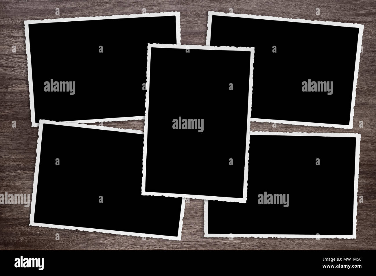 five blackened old vintage photo templates on rustic wooden background Stock Photo