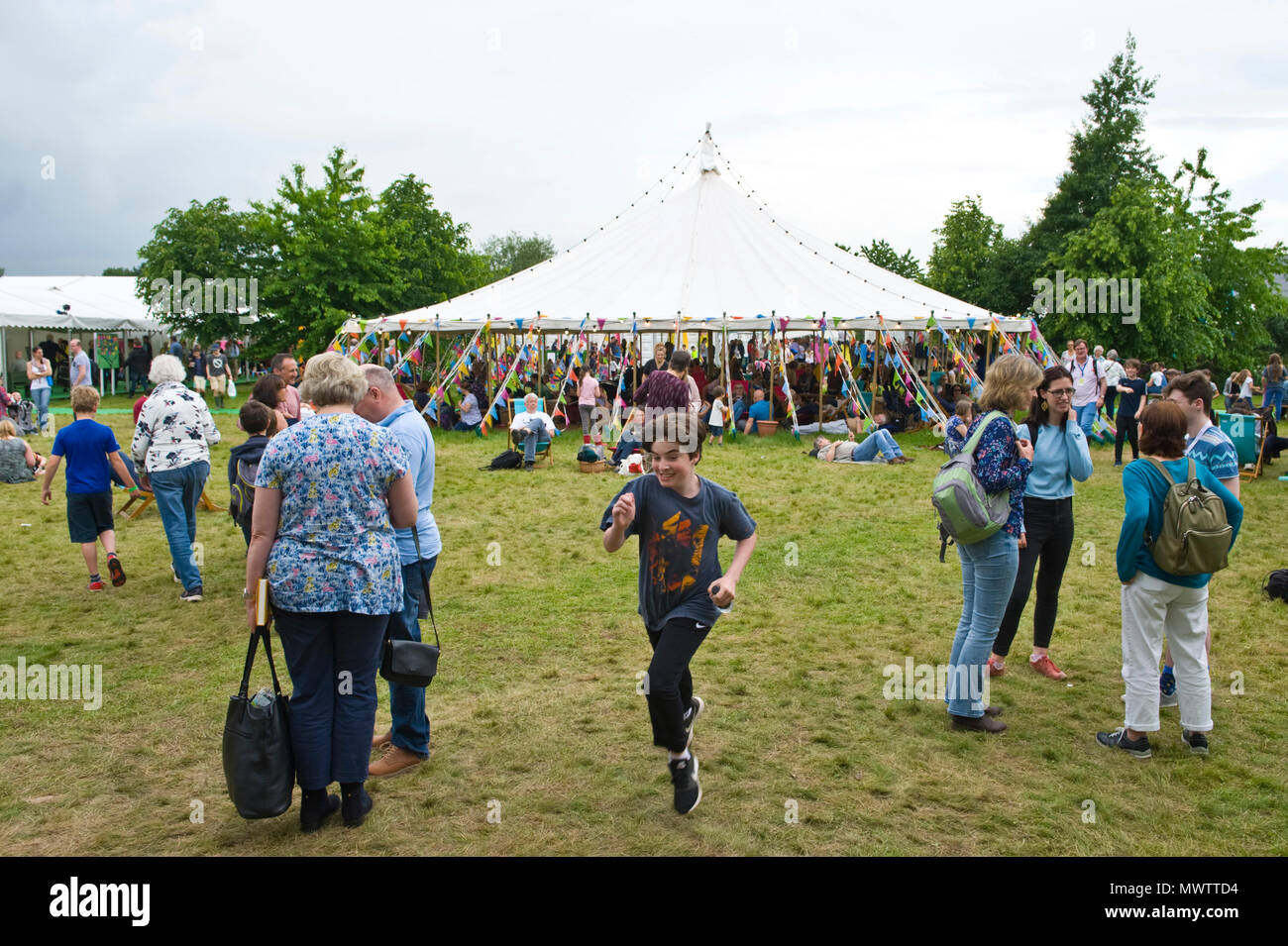 Visitors relaxing on the lawn in the garden area at Hay Festival 2018 Hay-on-Wye Powys Wales UK Stock Photo