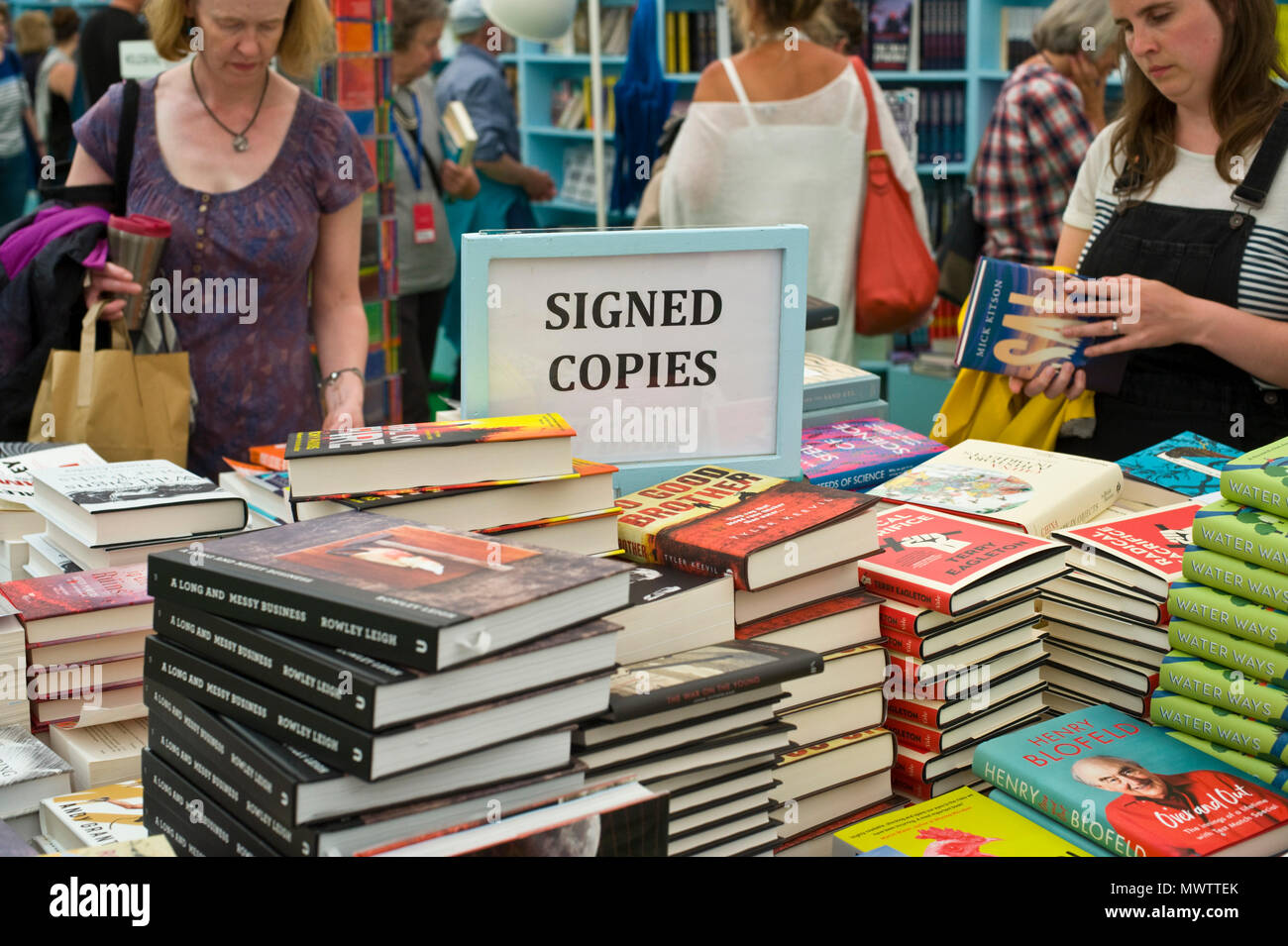 People browsing author signed copies of their books in the book shop at Hay Festival 2018 Hay-on-Wye Powys Wales UK Stock Photo