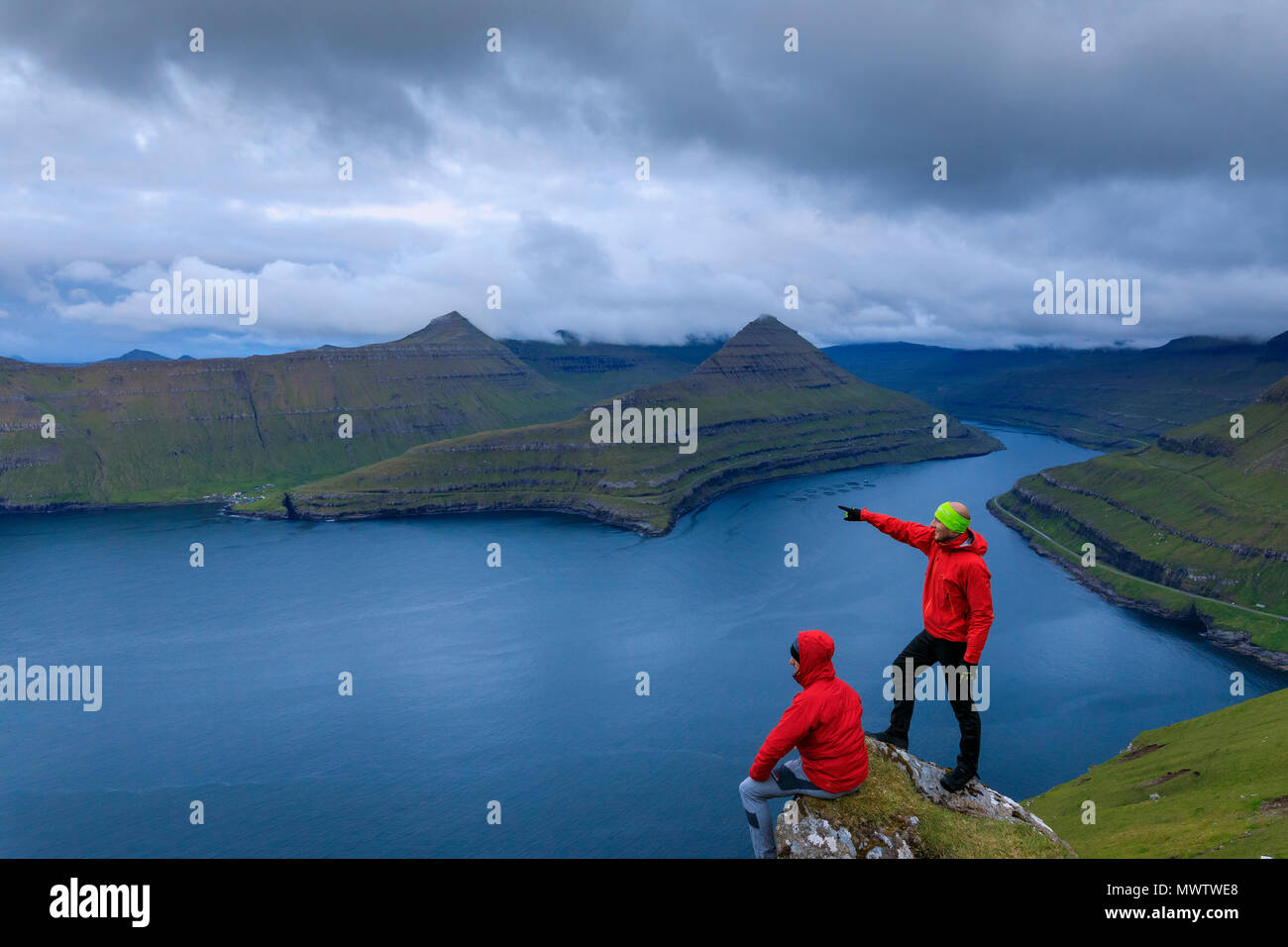 Hikers, Funningur fjord, Eysturoy Island, Faroe Islands, Denmark, Europe Stock Photo