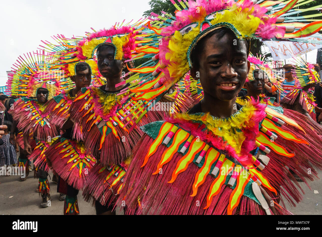 Four participants in flamboyant coloured dress marching at the annual ...