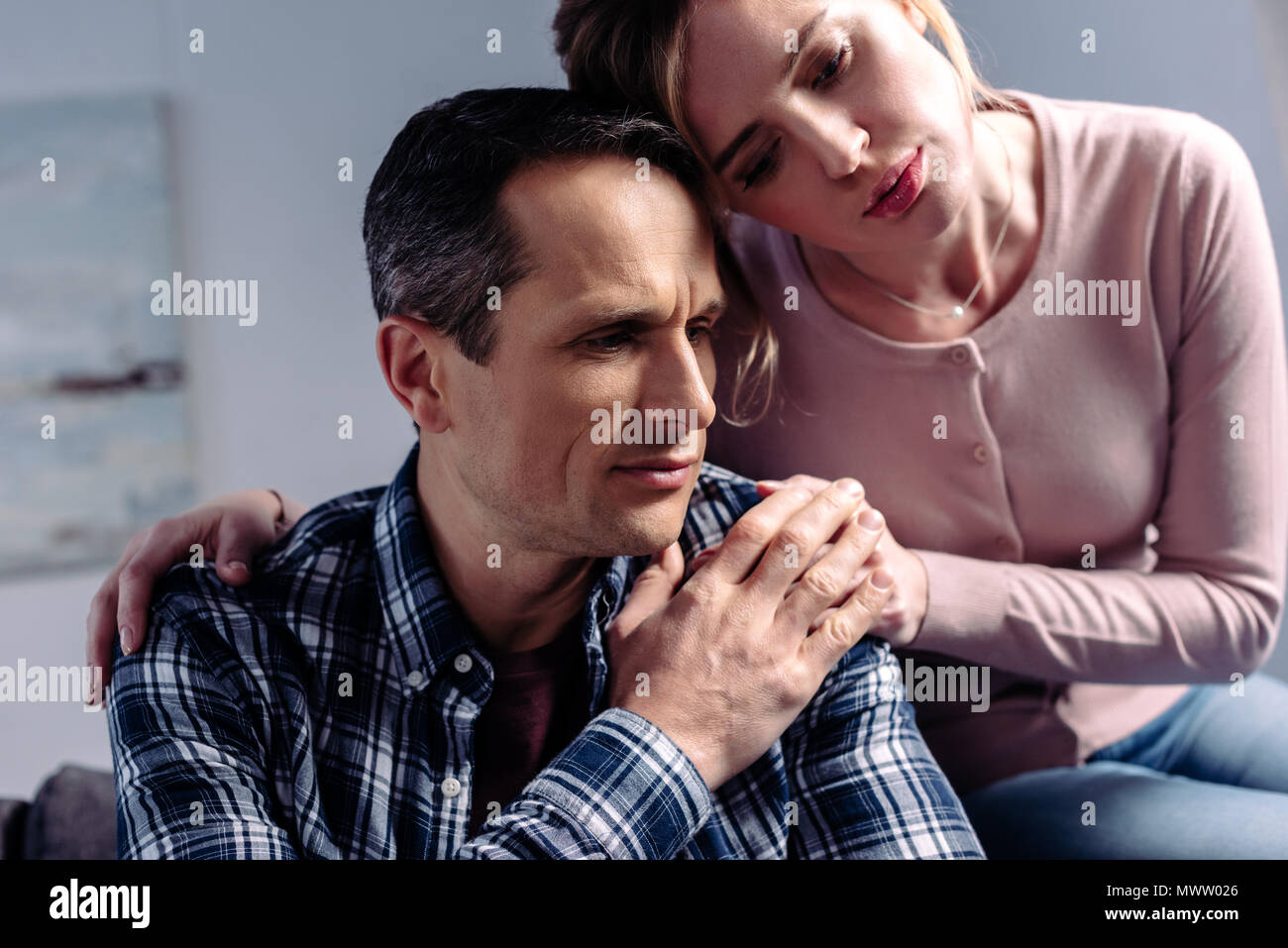 Woman hugging sad man hi-res stock photography and images - Alamy