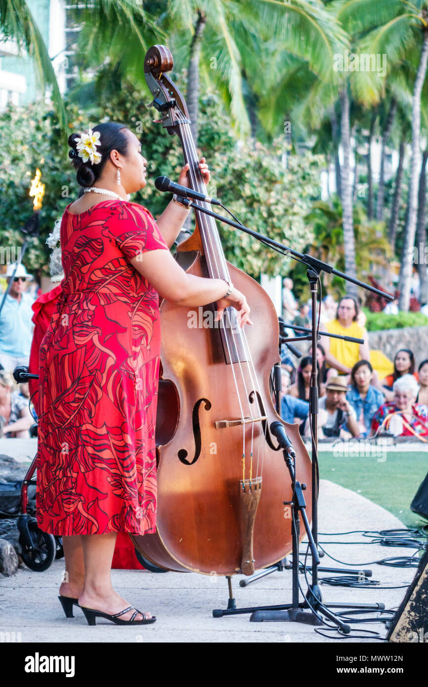 Hawaii,Hawaiian,Honolulu,Waikiki Beach,Kuhio Beach Park,Hyatt Regency Hula performer,free singer,musician,bass,muumuu,woman female women,microphone,US Stock Photo