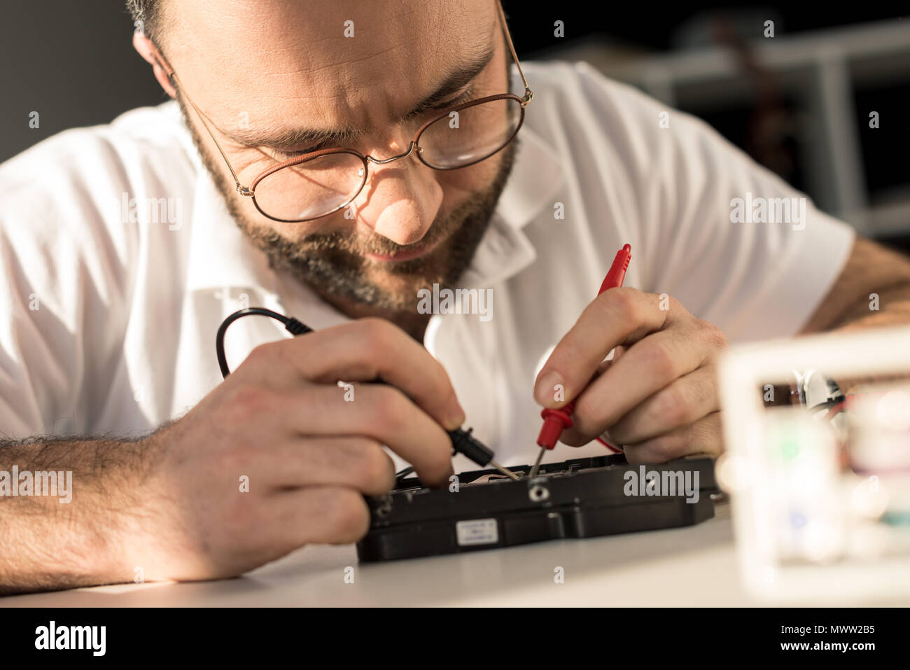 man using multimeter while testing hard disk drive Stock Photo - Alamy