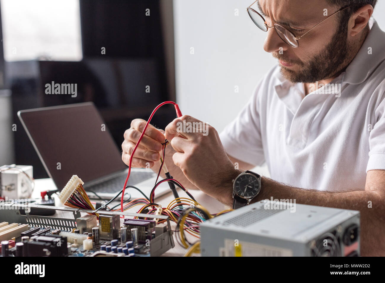 man using multimeter while fixing broken computer Stock Photo - Alamy