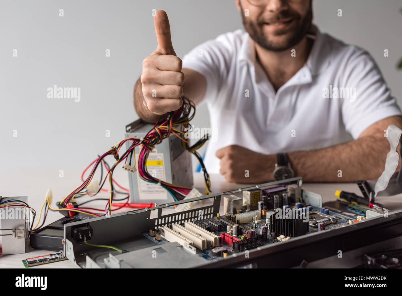 man showing thumb up against broken computer Stock Photo - Alamy